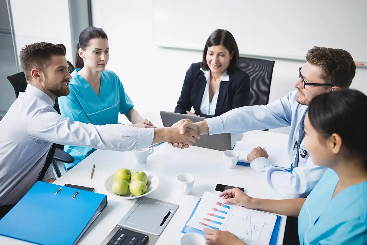 doctors shaking hands with each other.webp
